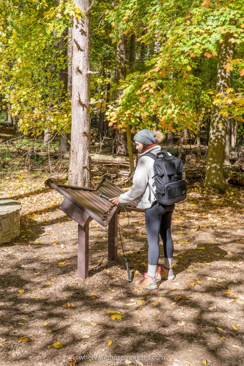 Woman playing a musical instrument along the Autism Nature Trail