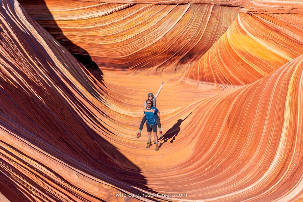 Couple hiking The Wave in Arizona enjoying the spectacular topography