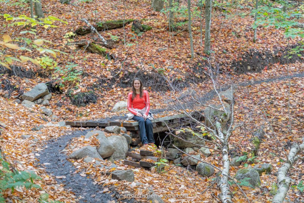 Woman sitting along the path of the Van Hoevenberg trail