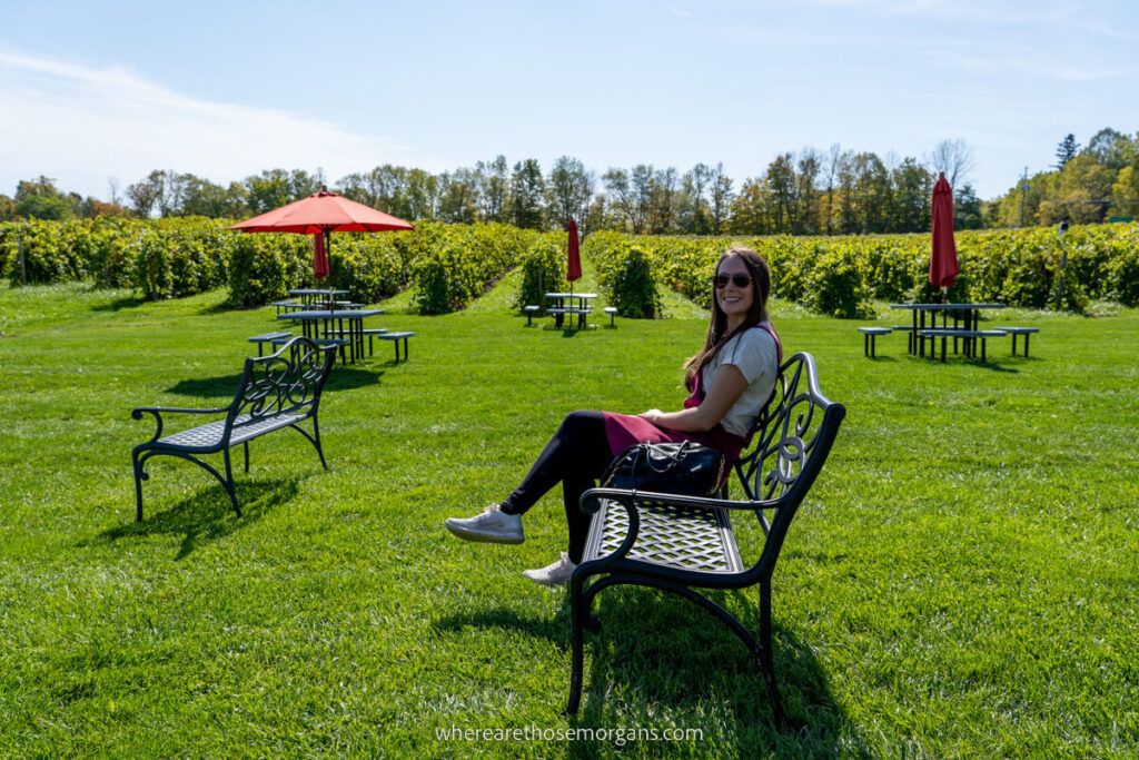 Woman sitting on bench at a finger lakes winery