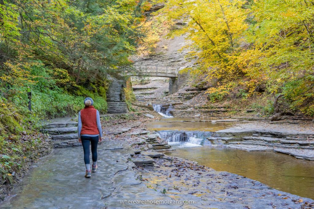 Person walking stone path next to Stony Brook in upstate New York
