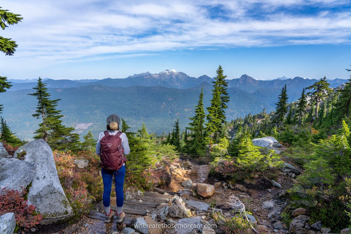 Hiker admiring views over Washington mountain peaks from a hike in the Cascades