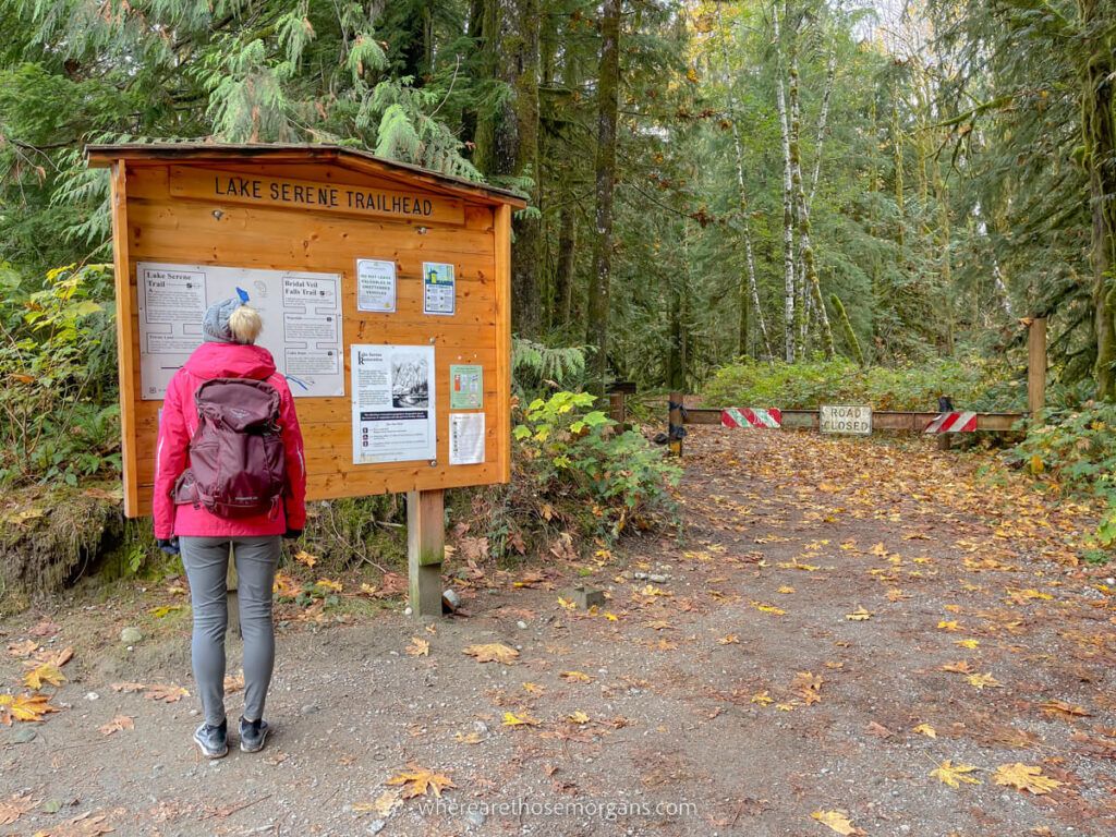 Hiker studying trailhead information board in Washington