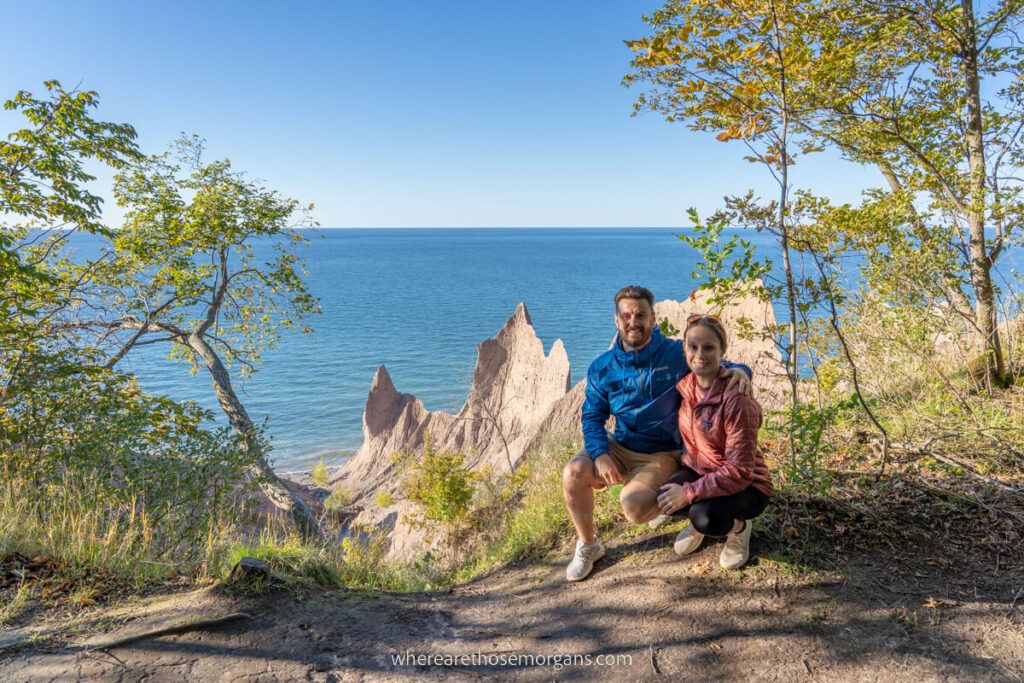 Two people posing together for a photo at Chimney Bluffs State Park