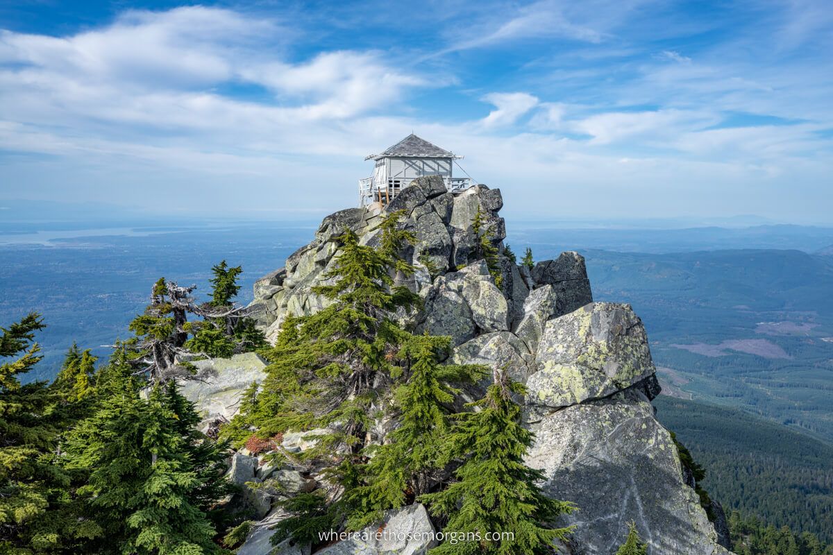 Mt Pilchuck Lookout fire tower perched on top of rocks on a steep cliff edge