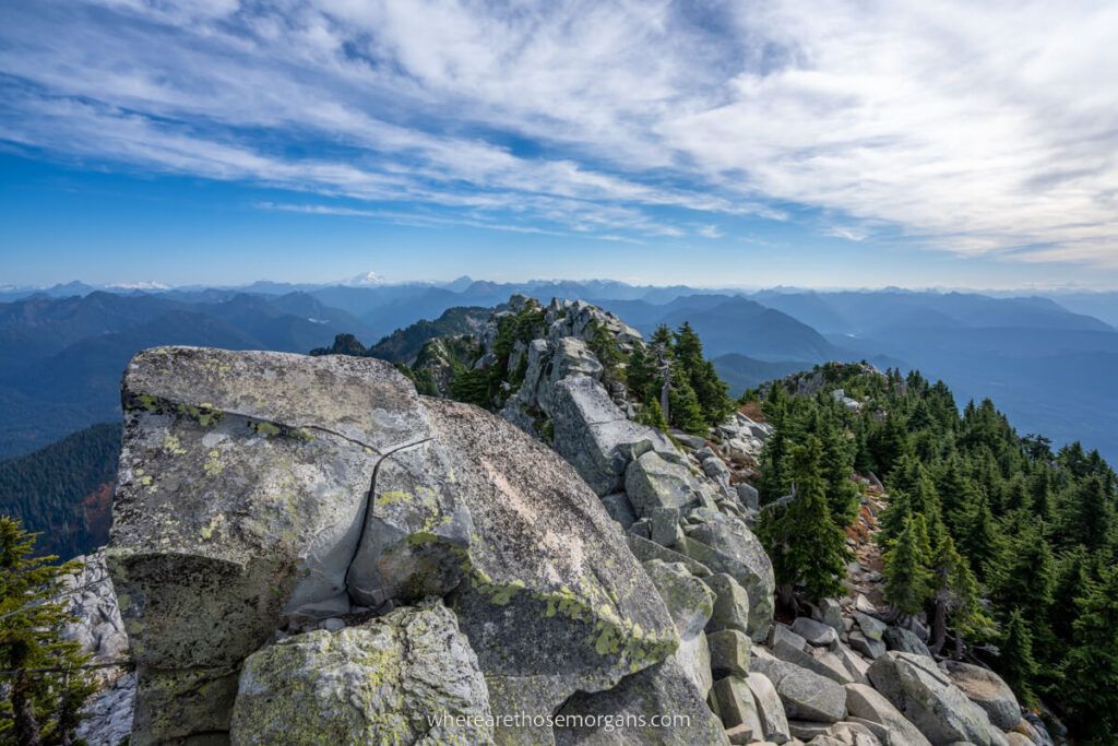 Huge boulders at the summit of Mount Pilchuck hiking trail with distant views over Washington
