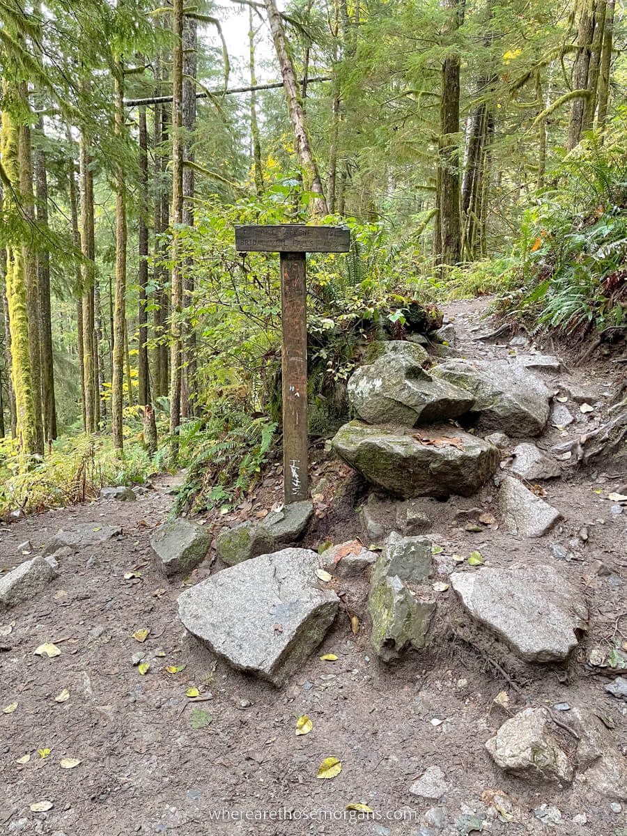 Trail marker with spur path as hike splits to Bridal Veil Falls and Lake Serene