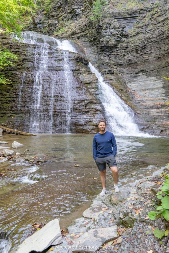 Man standing in front of Grimes Glen waterfall