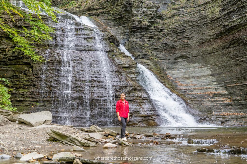 Woman standing in front of Grimes Glen waterfall