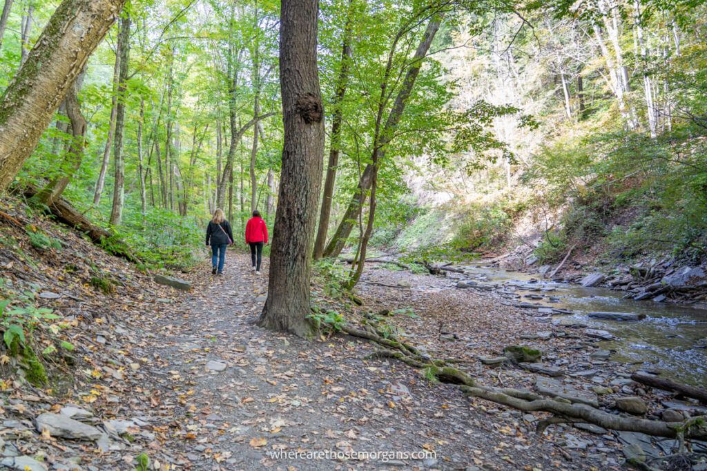 Two people walking along the Grimes Glen hiking trail in upstate New York