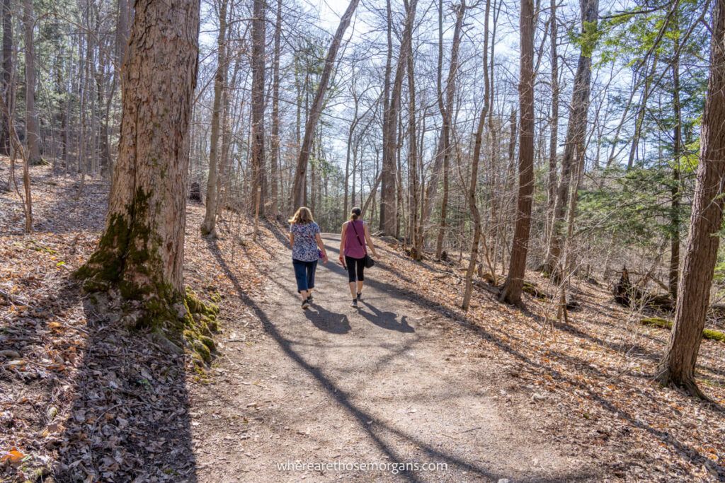Women walking along wooded trail at Green Lakes State Park