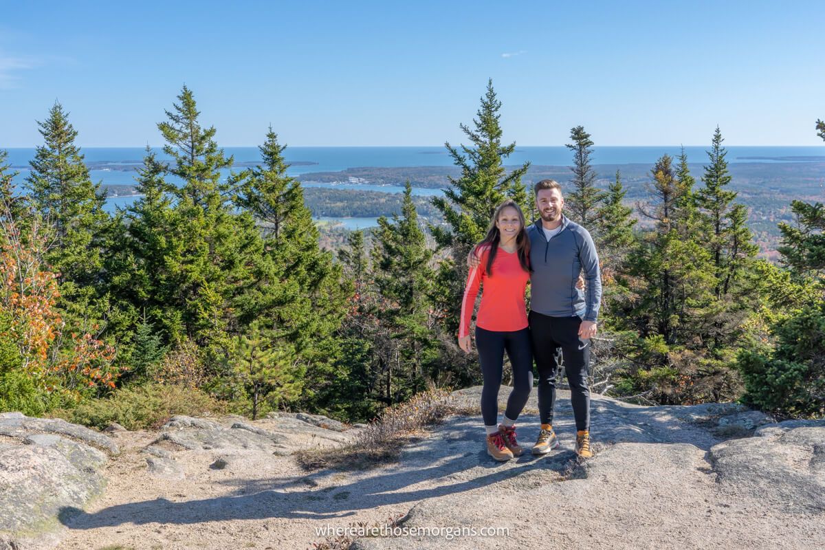 Couple hiking in Acadia national park in October with windy but warm weather