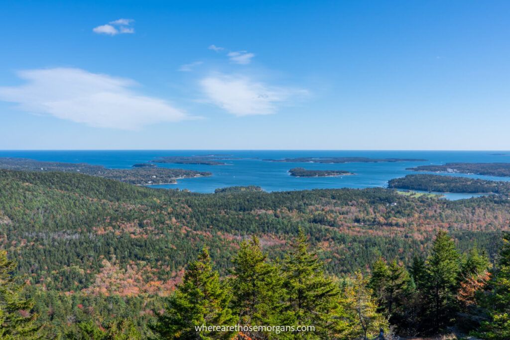 Distant views over rolling hills and the Gulf of Maine from a mountain peak in Acadia national park