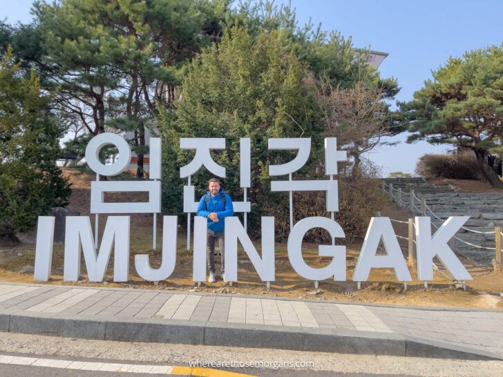 Man standing behind a large Imjingak park sign