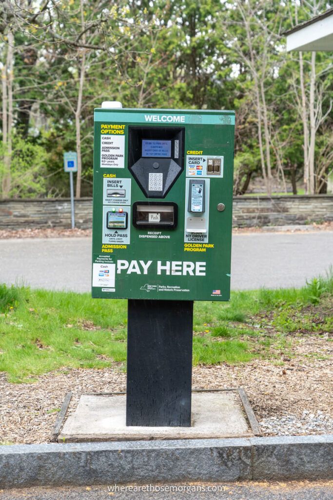 Green pay to park machine inside a New York State Park