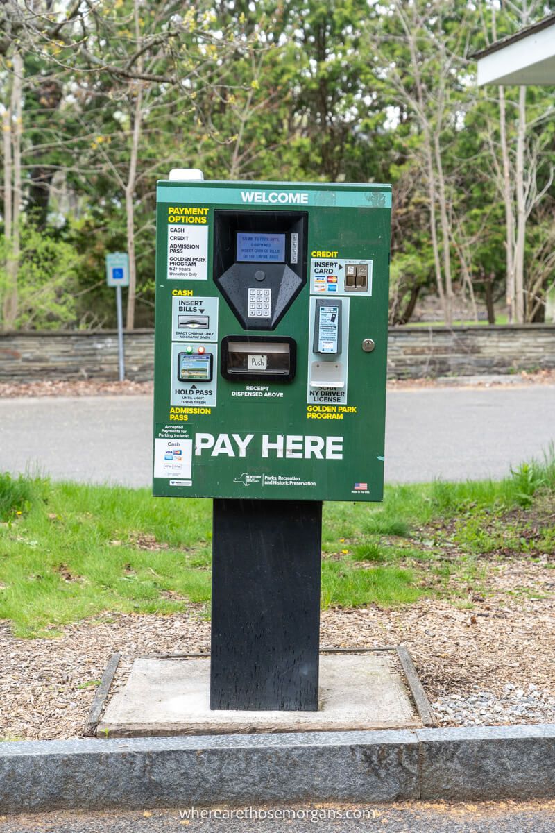 Green pay to park machine inside a New York State Park