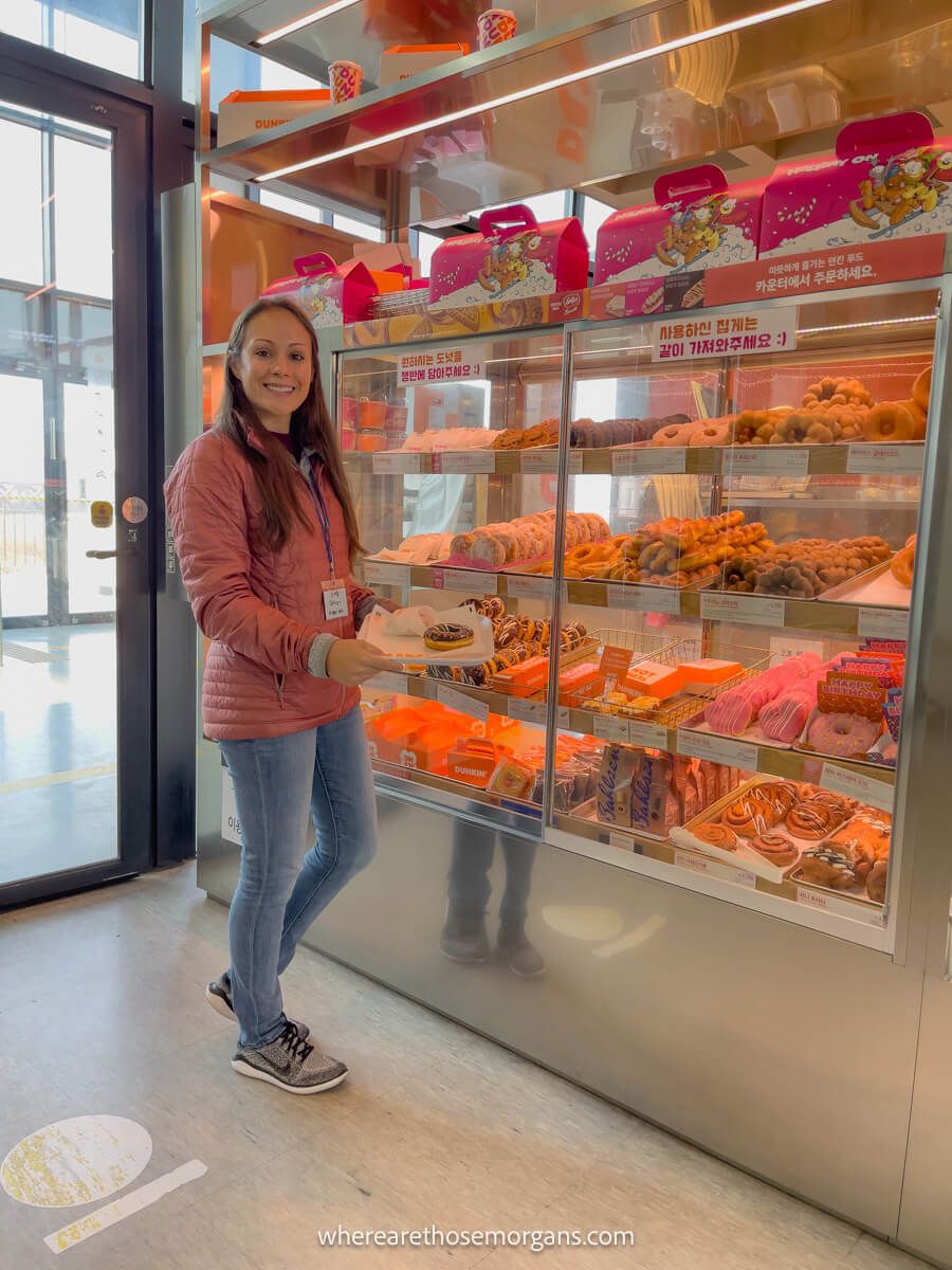 Woman purchasing two donuts at Dunkin donuts