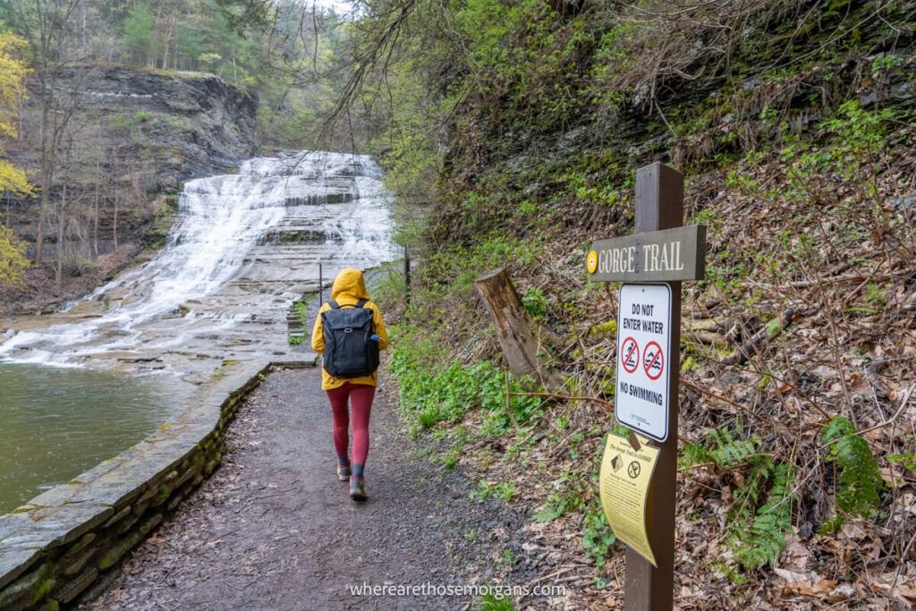 Woman walking towards the Buttermilk Falls State Park Gorge Trail