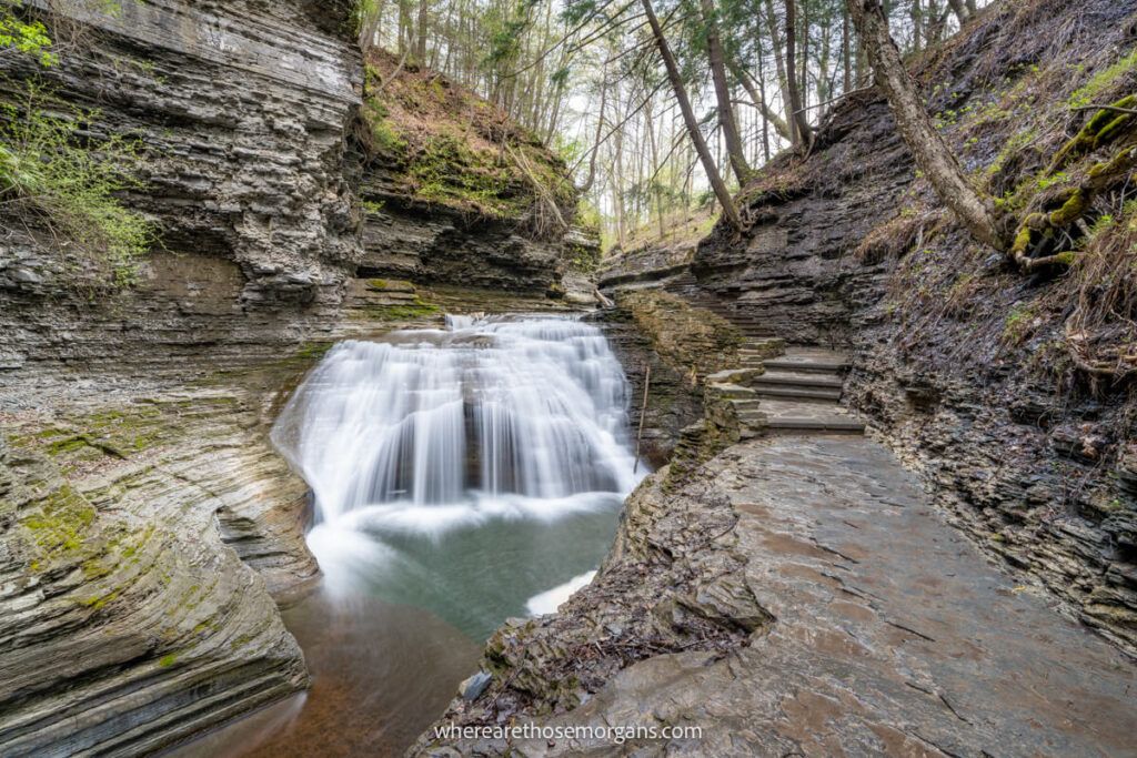 Waterfall next to a stone staircase during the spring in upstate NY