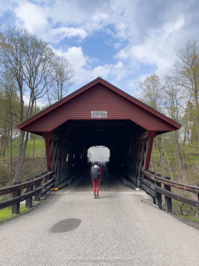 Woman in front of the Newfield Covered Bridge