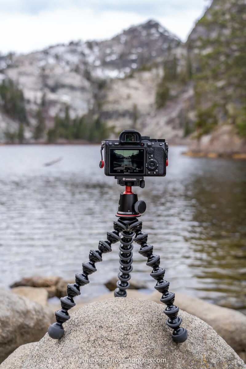 Camera mounted on a gorillapod tripod sat on a rock overlooking a lake