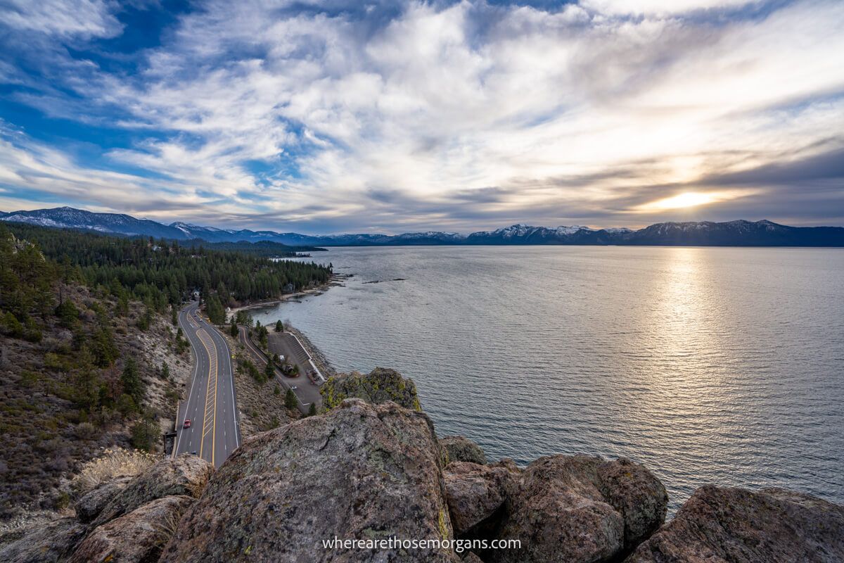 View overlooking water a road and sky as the sun is setting