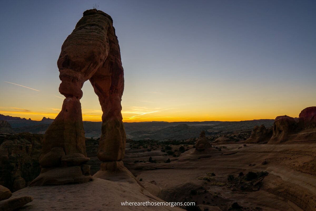 Famous arch formation at twilight with yellows and oranges in the sky