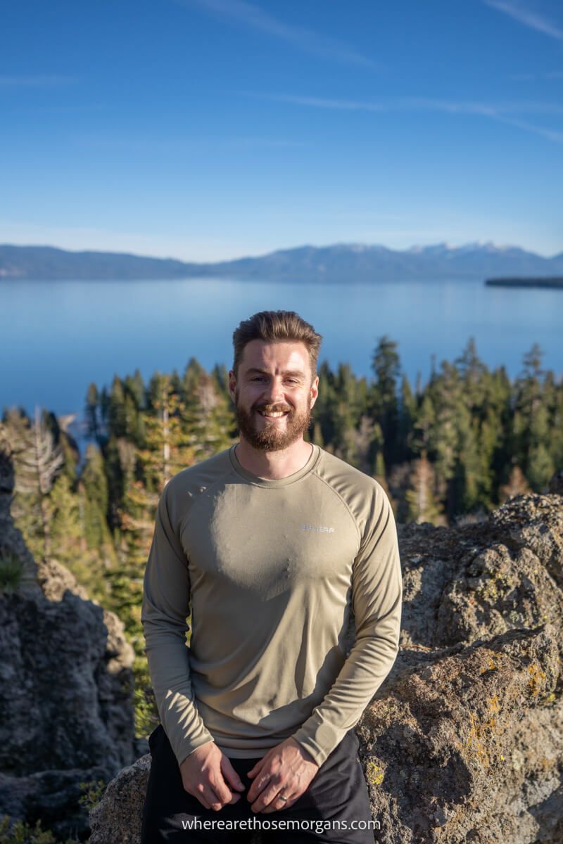 Hiker at a viewpoint in California overlooking a lake at dusk