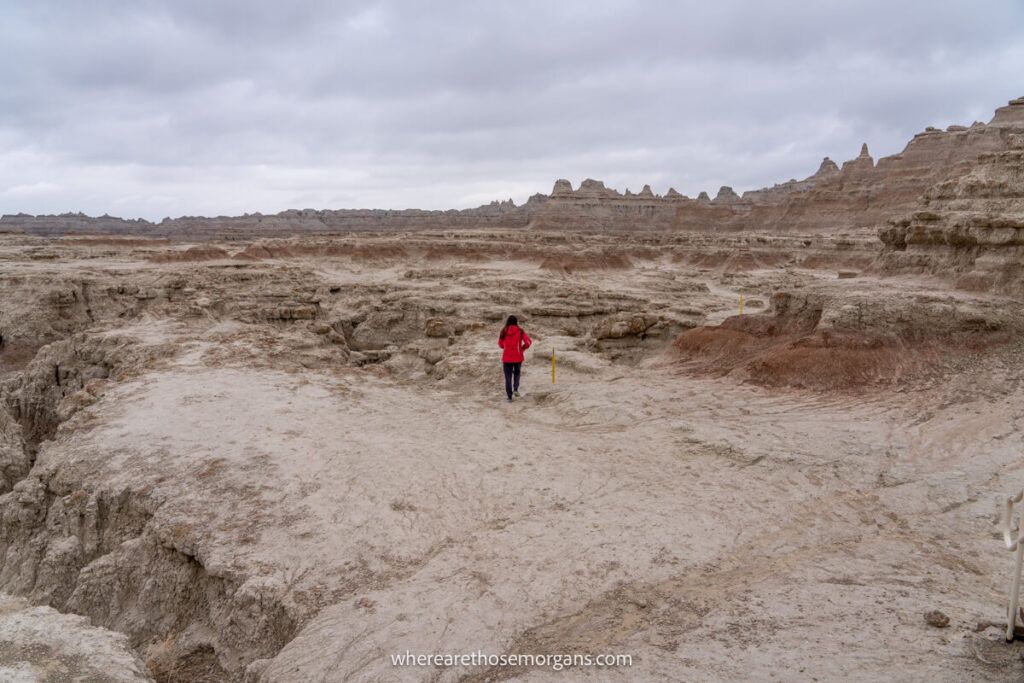 Woman walking through a section of sand formations