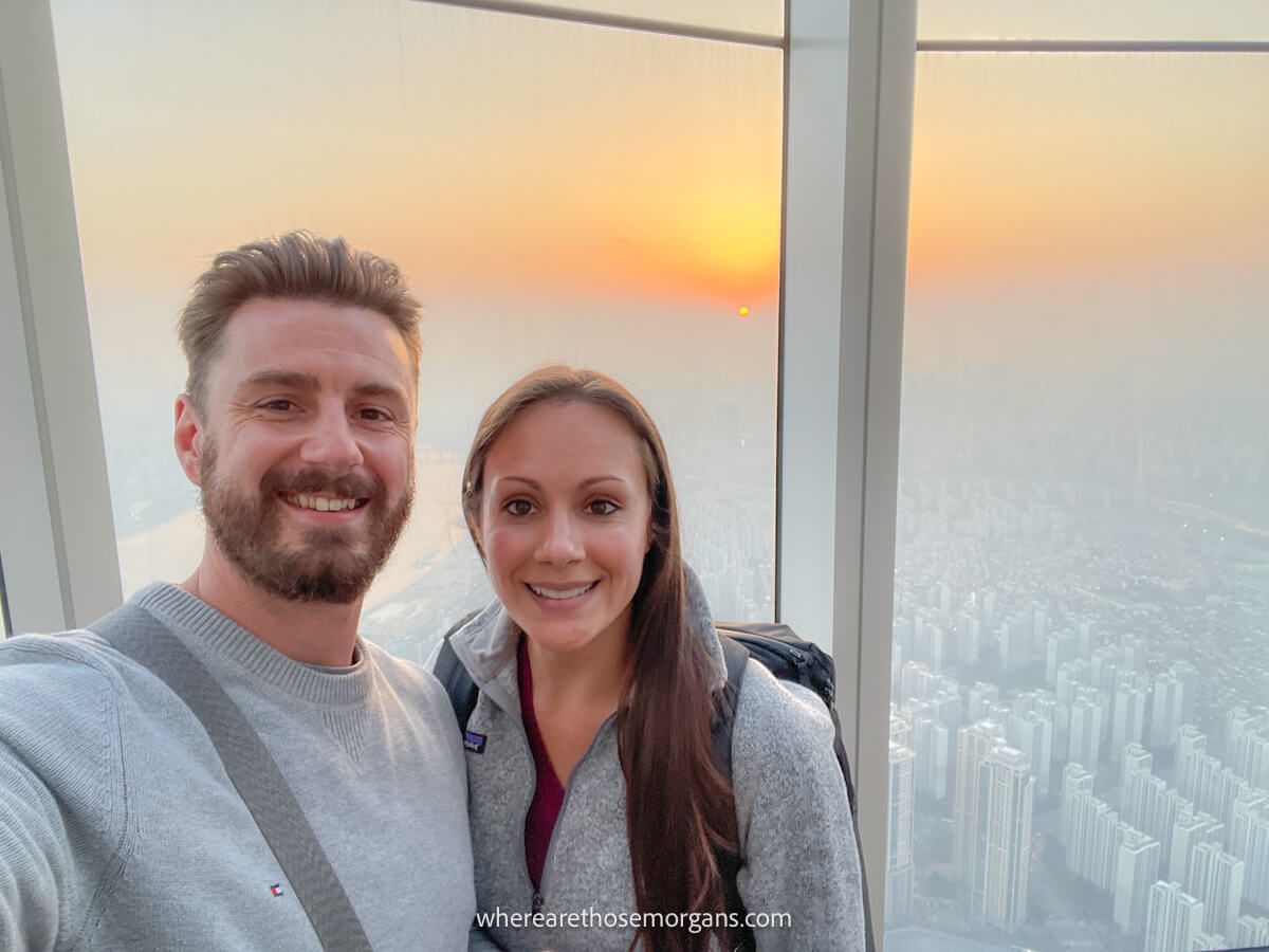 Man and woman at the top of the Lotte World Tower in Seoul Sky Observatory