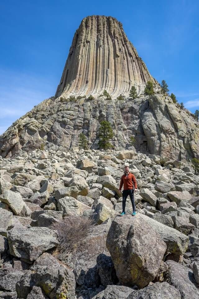 Man standing in front of the Devils Tower
