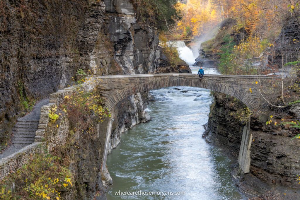 Hiker sitting on a stone staircase in Letchworth State Park