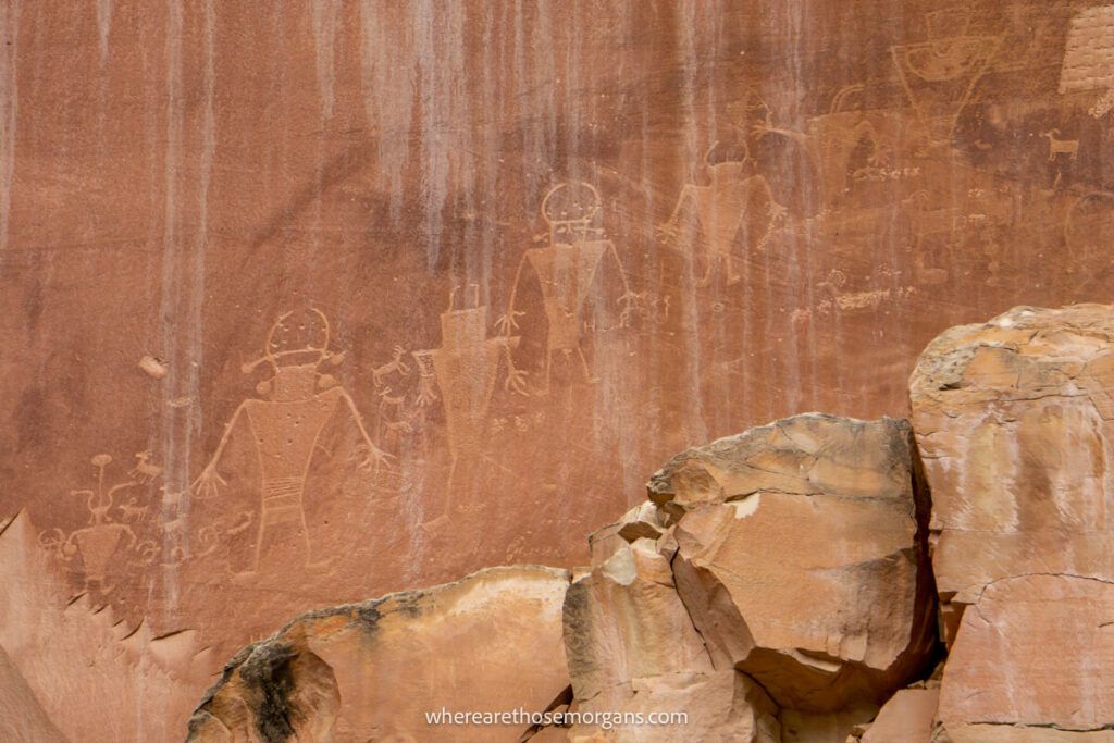Numerous images carved into a red rock in Utah