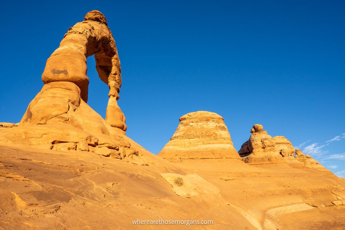 Several sandstone formations in a row on a sunny day with clear blue sky