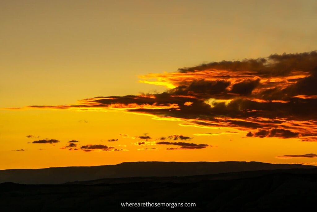 Bright yellow, orange and red clouds burning bright red during a sunset on the west coast