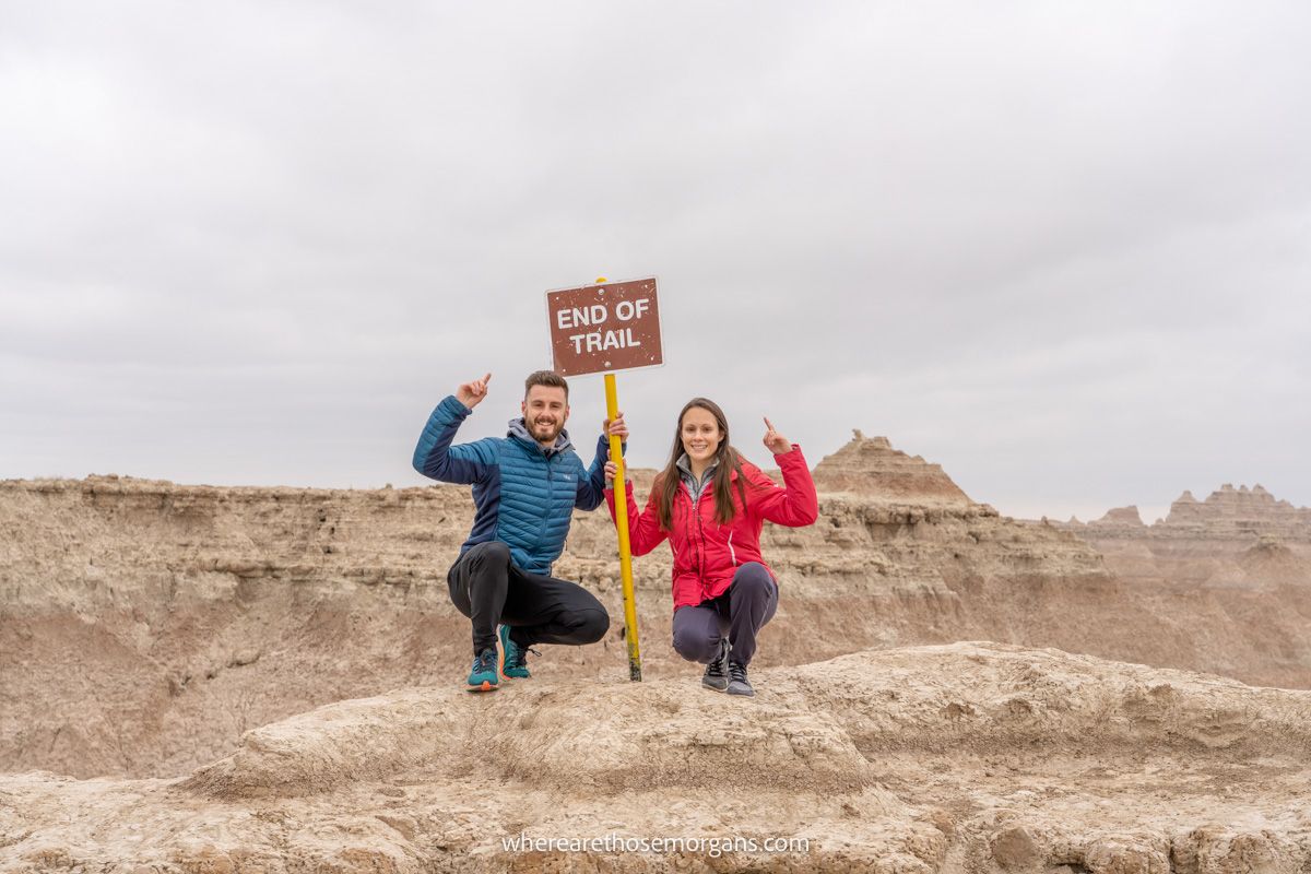 Two people hiking a trail in Badlands National Park
