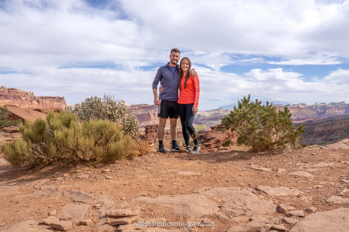 Two hikers posing for a photo during a hike along a dirt path