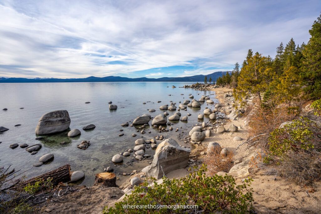 Empty beach with boulders and clouds in Lake Tahoe during november