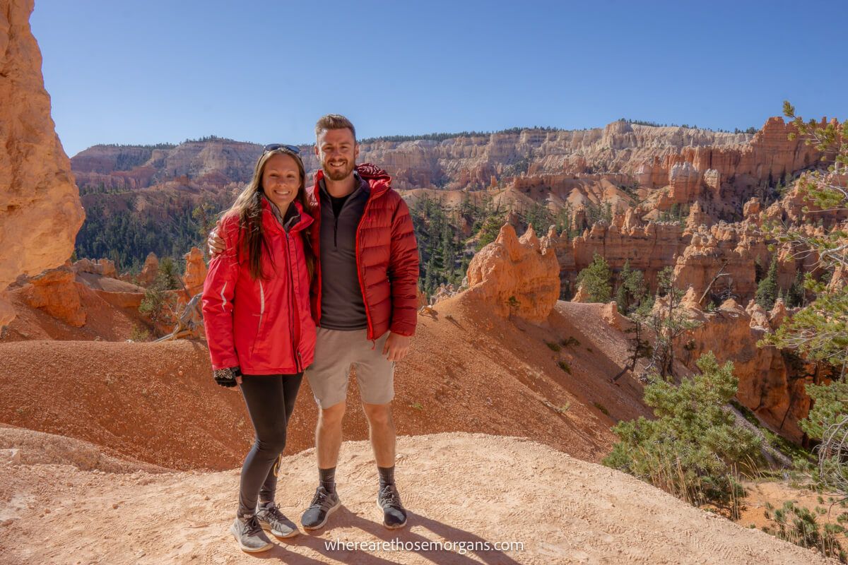 Two hikers having a photo taken in a sandstone landscape in Utah