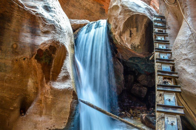 Ladder by the side of a waterfall in a slot canyon