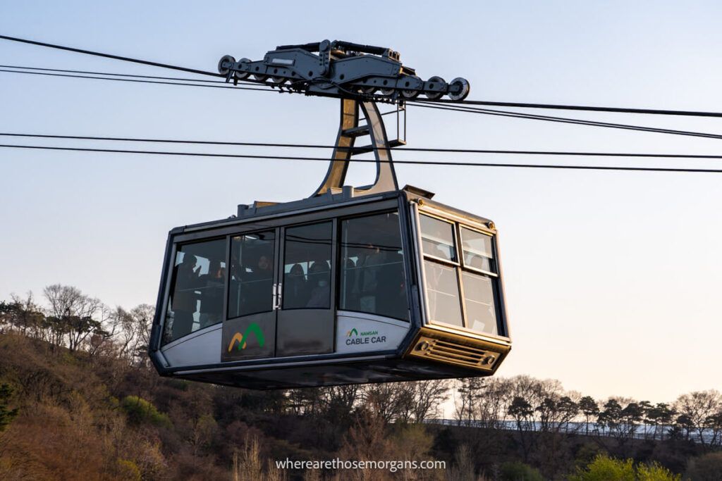 Namsan Cable Car filled with people heading to the top of namsan mountain