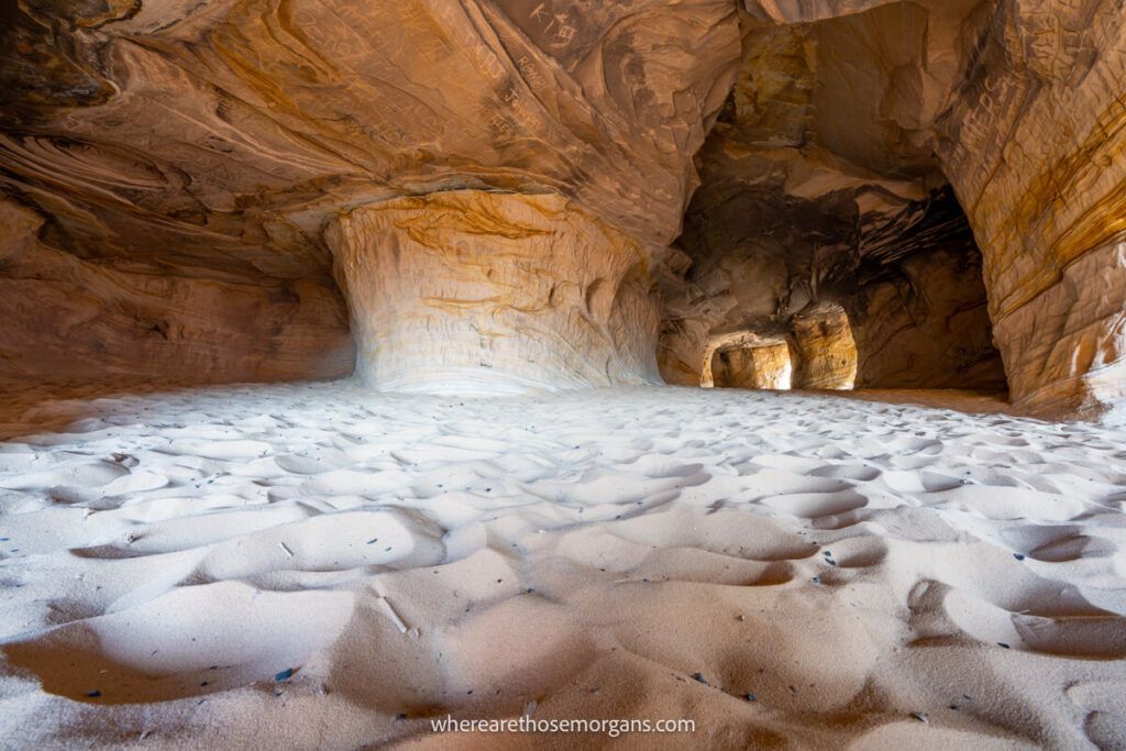 Caves filled with sand and light coming in through multiple natural windows