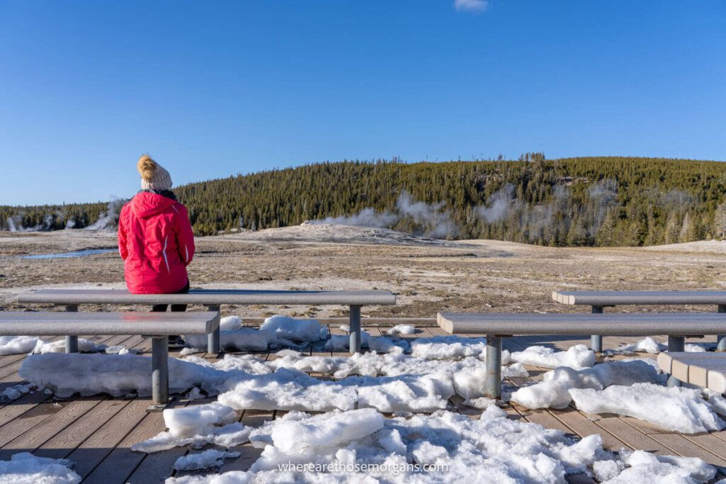 Woman waiting for Old Faithful to erupt in thew main viewing area for the geyser