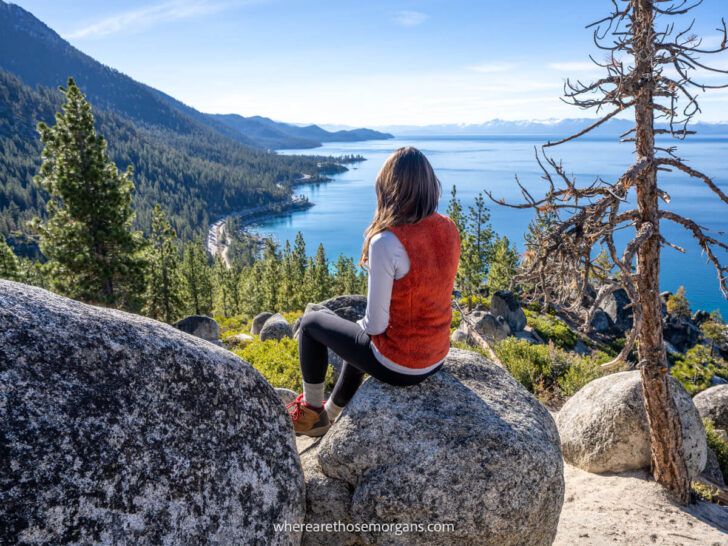 Hiker sat on a rock with back turned overlooking Lake Tahoe during a November visit to California and Nevada