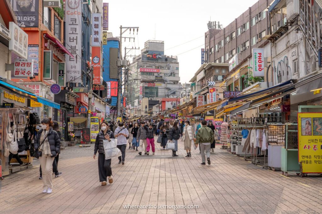 Visitors and tourists walking through a busy street in Hongdae