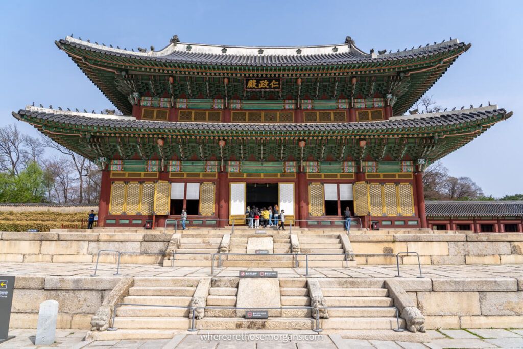 Injeongjeon Hall with visitors waiting in line to peek inside
