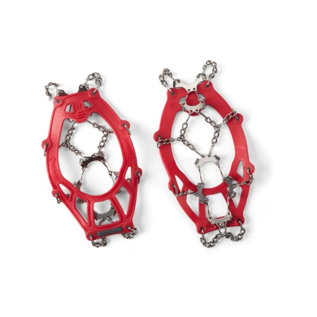 Pair of red Kahtoola MICROspikes for hiking in cold conditions