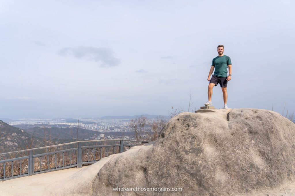 Man climbing to the top of Inwangsan Peak one of the best hikes in Seoul