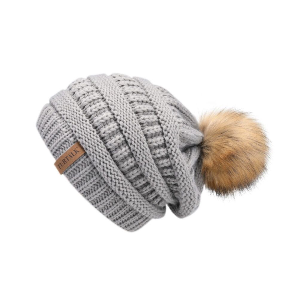 Grey slouchy beanie hat with a pom pom makes a great present for outdoor women