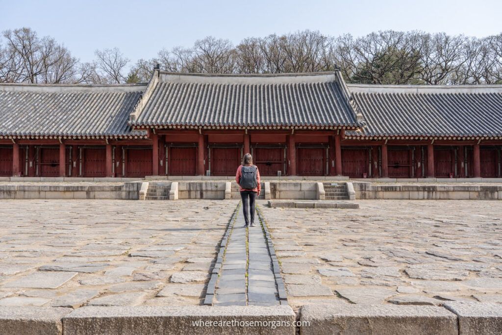 A woman walking up to the Jongmyo Shrine one of the best places to visit in Seoul
